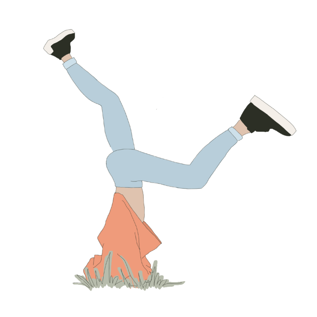 Woman doing handstand in the grass